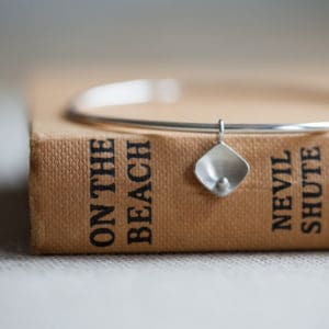 recycled silver bangle with pearl charm